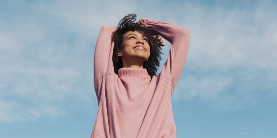 Portrait of happy young woman enjoying sunlight