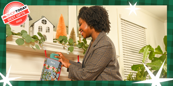 Woman stuffing a stocking on a mantel