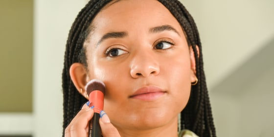 Woman putting on makeup