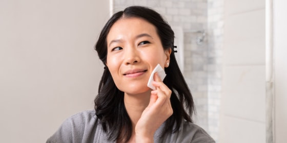 Woman using a face pad on her cheek