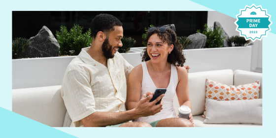 Couple sitting onside on their phone