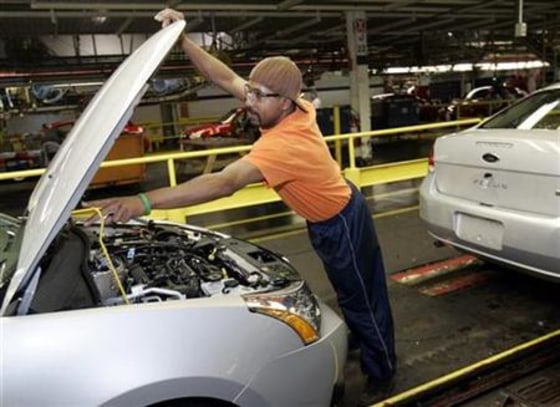 A Ford Motor Company employee works on the assembly line of the 2008 Ford Focus vehicle at the Wayne Stamping and Assembly Plant in Wayne, Mich.