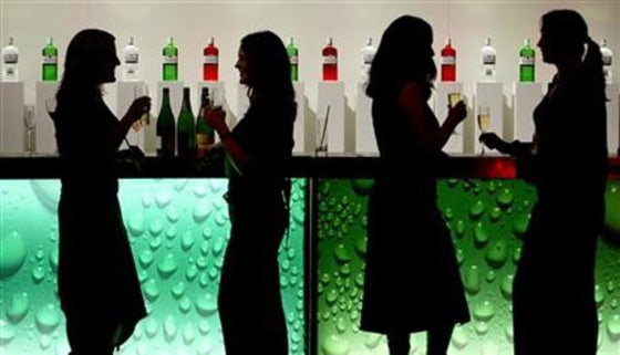 File photograph shows women drinking at a party in a bar in central London.