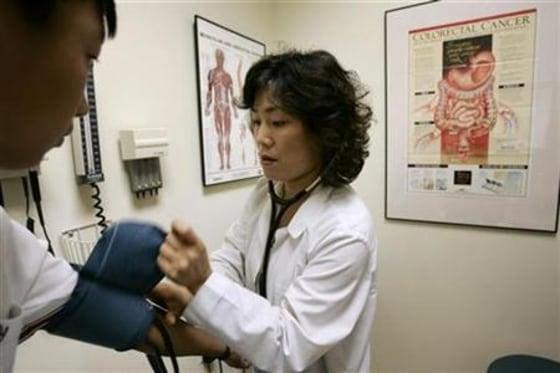 Internal medicine specialist Dr. Ingrid Chung checks for blood pressure during a medical exam at her practice in Chantilly Virginia