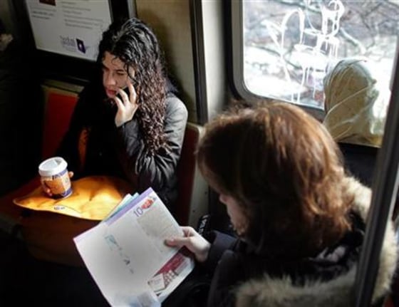 Woman talks on her cell phone on a subway train in New York