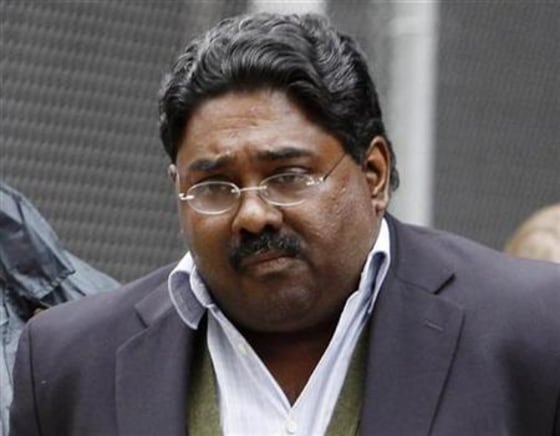 Galleon hedge fund partner Rajaratnam is escorted by FBI agents after being taken into custody in New York