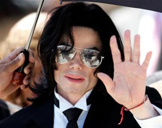 Michael Jackson waves to supporters as he leaves the Santa Barbara County Courthouse after he was fo..