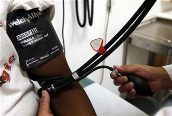 A doctor checks the blood pressure of a patient at the J.W.C.H. safety-net clinic in downtown Los Angeles