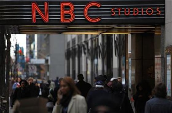 Pedestrians walk outside the NBC studios at the General Electric building in New York