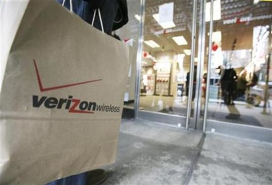 A customer stands outside of a Verizon Wireless store waiting to purchase the new Blackberry Storm phone in New York