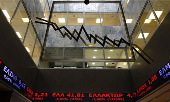 Stock prices are pictured on display inside the Athens' Stock exchange in Athens