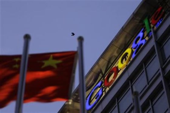 A bird flies over Google China headquarters building next to a Chinese national flag in Beijing