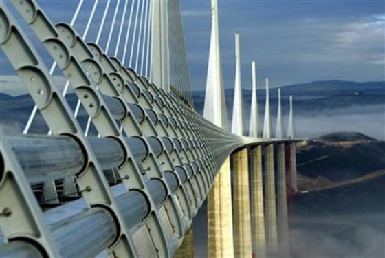 BEST QUALITY AVAILABLE Pillars from the Millau Viaduct rise above clouds over the river Tarn in France