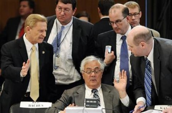 Frank talks with a group including Bachus during a recess from a committee conference on Wall Street reform on Capitol Hill