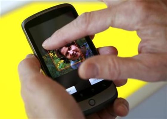 A model demonstrates the Nexus One smartphone, the first mobile phone Google will sell directly to consumers, after a news conference in Mountain View