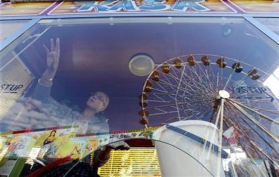 A ticket vendor cleans a window of her cash counter in Prague's Holesovice fairground