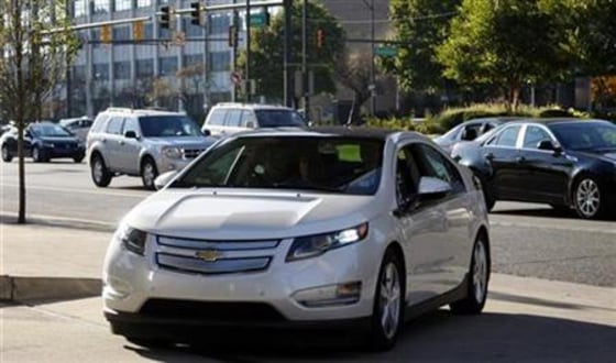 An electric Volt vehicle driven by General Motor Co Vice Chairman Tom Stephens pulls into the front of GM's world headquarters in Detroit
