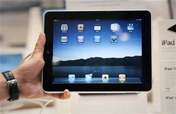 A salesman displays an Apple iPad during its launch in Singapore