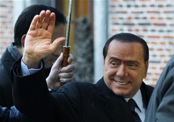 Italian Prime Minister Silvio Berlusconi waves as he arrives at an European People's Party meeting in Meise