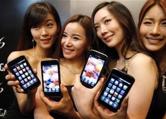 Models pose with the new Samsung Galaxy S Android smartphone during its launch ceremony at the headquarters of Samsung Electronics in Seoul