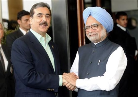 Pakistan's PM Gilani shakes hands with his Indian counterpart Singh in Mohali