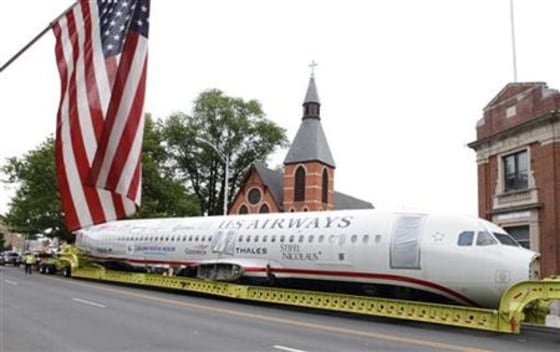 U.S. Airways flight 1549 also known as the \"Miracle on the Hudson\" is hauled on a truck through the streets in Elizabeth, New Jersey