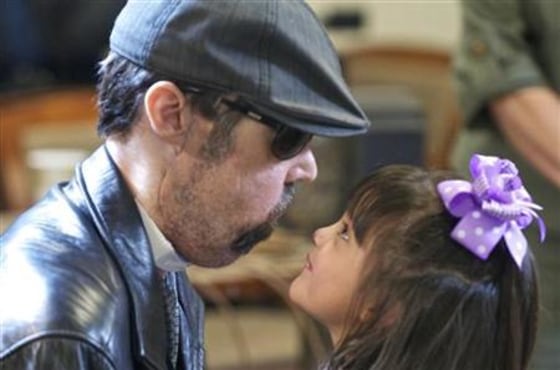 Handout image of full face transplant patient Dallas Wiens and his daughter Scarlette