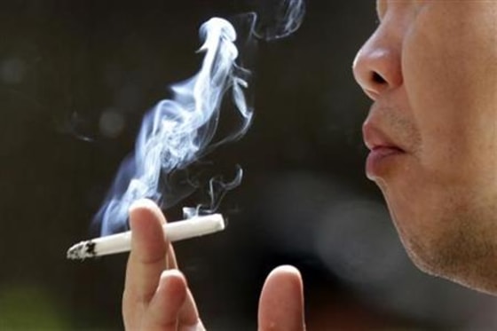 A man smokes outside the Taipei railway station January 13, 2010. REUTERS/Pichi Chuang