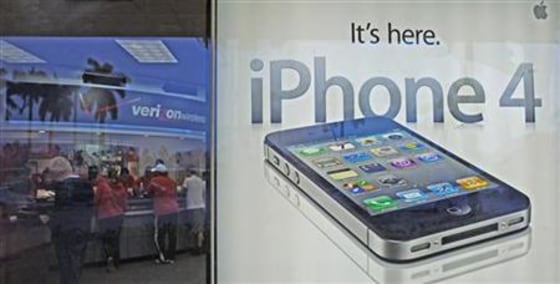 Customers purchase the iPhone 4 shortly after the phone went on sale with the Verizon Wireless network, in Boca Raton