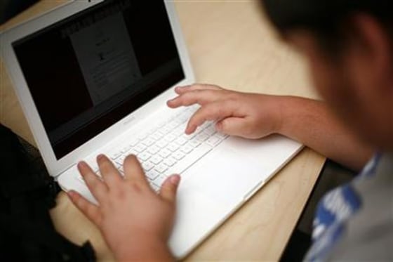 A student sets up a laptop computer