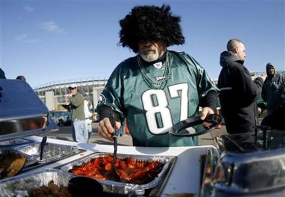 A Philadelphia Eagles fan helps himself to some hot dogs during a tailgate party before the Indianapolis Colts versus the Philadelphia Eagles game in Philadelphia