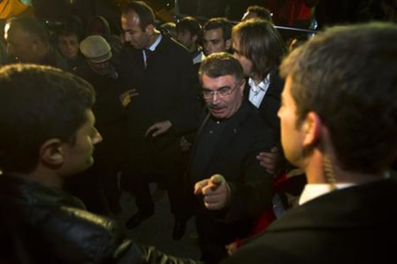 Turkish Interior Minister Naim Sahin gestures while visiting relief shelter campsite for earthquake victims in Ercis