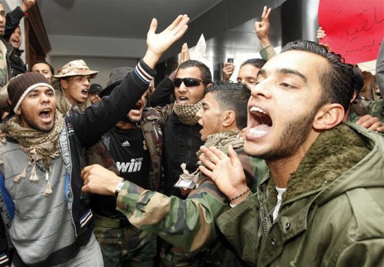 Former fighters protest at the office of Libya's Prime Minister Abdurrahim El-Keib in Tripoli