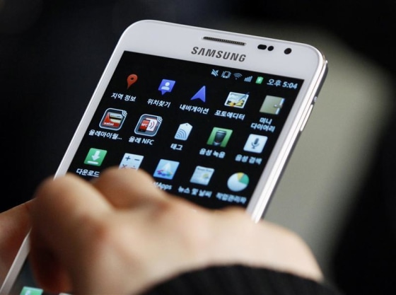 A customer tries Samsung Electronics' Galaxy smartphone at a store in Seoul