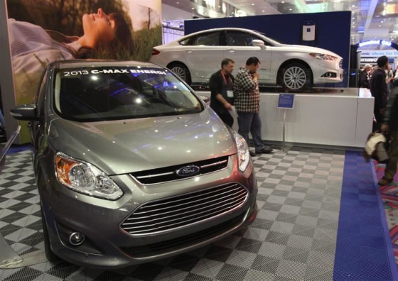 The 2013 Ford C-Max Energi and 2013 Ford Fusion Energi hybrids are displayed during the 2012 CES in Las Vegas