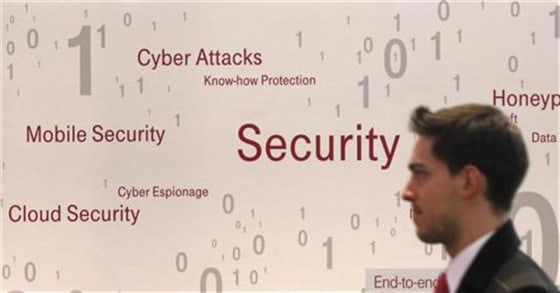 A visitor walks past an advertising billboard for security software application at the CeBit computer fair in Hanover