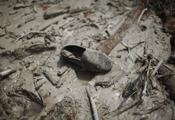 A shoe is pictured at an area that used to be a small village, swiped away by a flash flood caused by an avalanche in the Annapurna mountain range on Saturday, in Kaski district