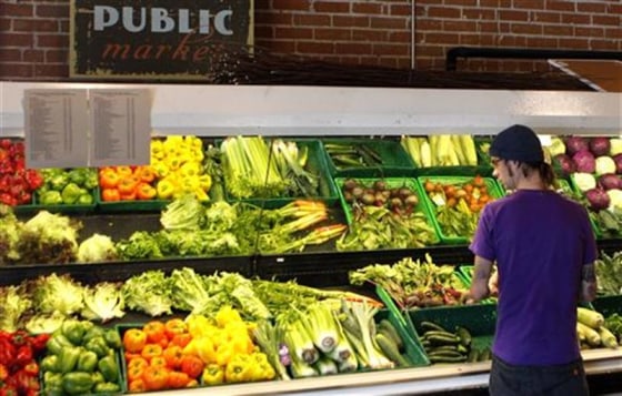 A customer looks over produce at the Phoenix Public Market in Phoenix