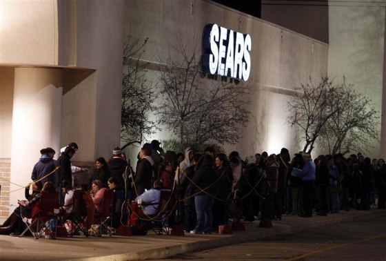 People wait outside a Sears store on the Thanksgiving Day holiday in Manchester