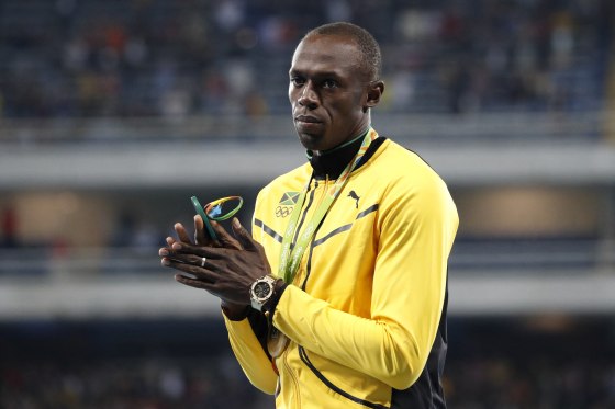 Usain Bolt with his gold medal on the podium of the men's 100-meter dash in Olympic Stadium in Rio de Janeiro on Aug. 15, 2016.