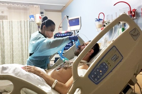 Solangi Urueña helps her husband, Hernando Rodríguez, in the hospital after he contracted Covid-19 and Guillain-Barré syndrome.