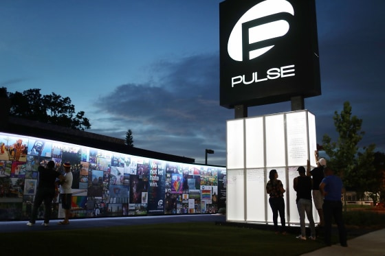 Image: Visitors at the memorial to the shooting victims setup at the Pulse nightclub in Orlando, Fla., on June 11, 2018.