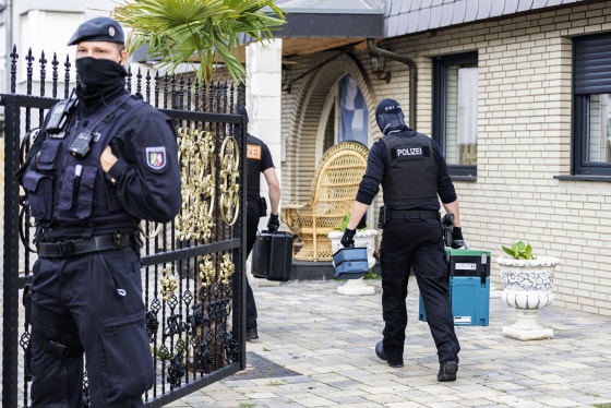 A police officer guard a house in Leverkusen, Germany, on June 8, 2021.