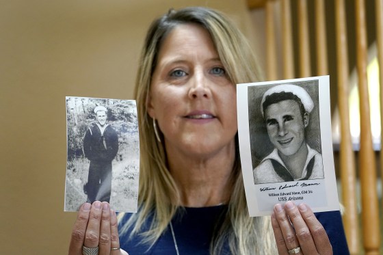 Image: Teri Mann Whyatt displays photos of her uncle, William Edward Mann, who died on the USS Arizona during the bombing of Pearl Harbor, at her home on July 14, 2021, in Newcastle, Wash.