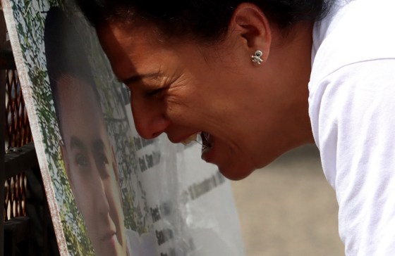 Image: A woman cries at the Glorieta de los Desaparecidos monument in Guadalajara, state of Jalisco, Mexico, on Aug. 29, 2021. The monument displays photographs and data of missing persons.