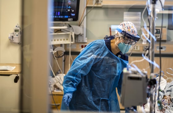 A registered nurse works in the ICU with a Covid-19 positive patient at Martin Luther King Jr. Community Hospital (MLKCH) on Dec. 31, 2021 in Los Angeles.