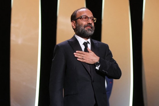 Image: Asghar Farhadi celebrates on stage after he was awarded the Grand Prix for "Hero" during the closing ceremony of the Cannes Film Festival on July 17, 2021.