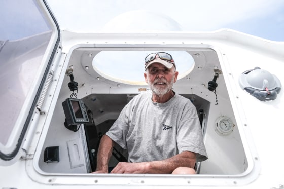 Jean-Jacques Savin looks out from his rowboat at a shipyard in Lege-Cap-Ferret, southwestern France, on May 28, 2021.