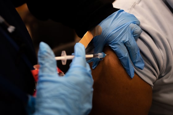 A health worker administers a Covid-19 vaccination in Philadelphia on Dec. 20, 2021.