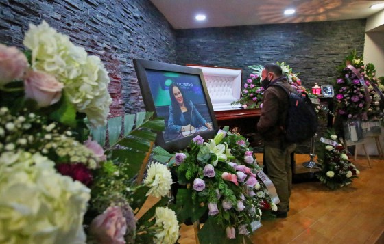 Image: A journalist looks on near the coffin of Mexican journalist Lourdes Maldonado during her wake in Tijuana